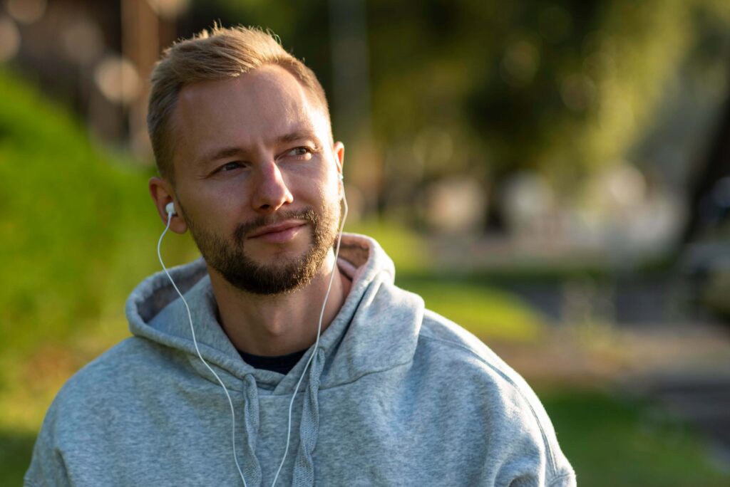 man with headphones relaxing outdoors